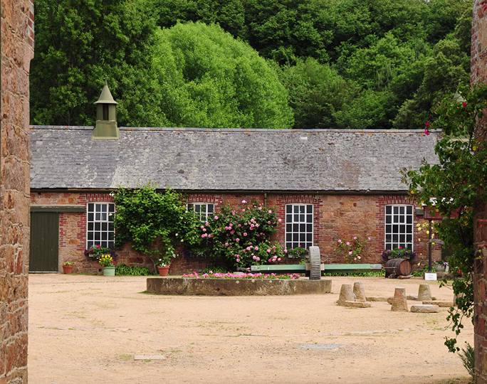Single-storey bungalow with a slate roof, brick façade and climbing roses, purchased using a chain break bridging loan